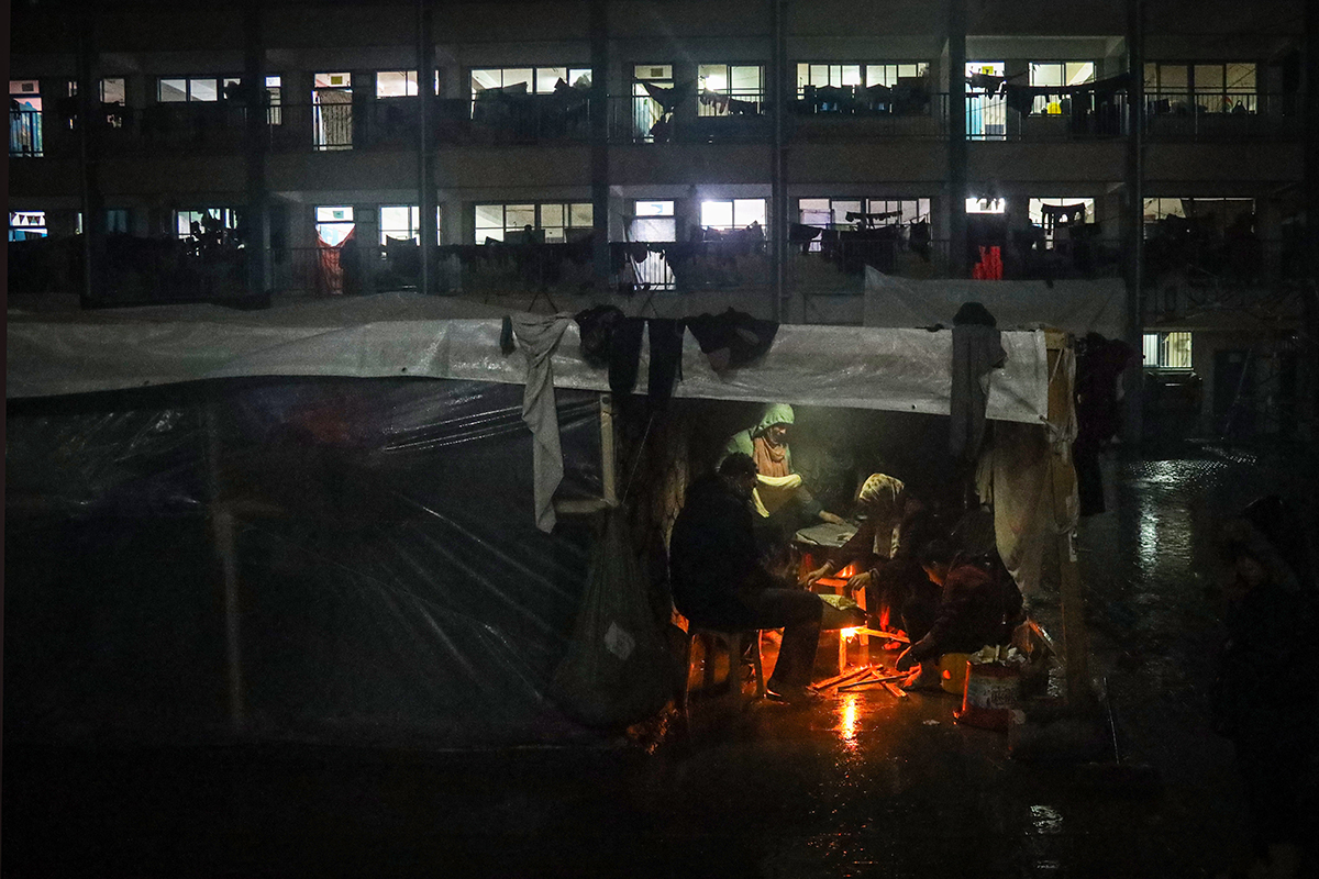 A Palestinian family is seen at a shelter during a rainy night in the city of Rafah, Gaza. Photo: UNICEF/Eyad El Baba