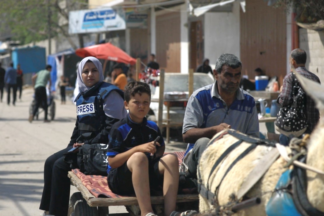 Hanin Hamaduna, a Gazan journalist and a mother, using a donkey cart to move from one location to another. Photo: Mohammad Abdallah, Gaza