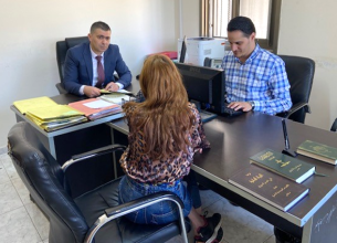 Public Prosecutor and Family Protection Prosecution from Violence Designee Abdel Latif Natour (left) consults with a survivor of violence seeking legal services. Photo © Abdel Latif Natour.
